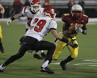 Cardinal Mooney's C.J. Amill (2) attempts to juke around Steubenville's Niko Petrides (29) during the second half of Friday nights Division four Semi-Finals matchup at Fawcett Stadium in Canton. Amill rushed 17 times for 82 yards and a touchdown in Mooney's 37-7 victory over the Big Red.  Dustin Livesay  |  The Vindicator  11/29/30  Fawcett Stadium, Canton Ohio.