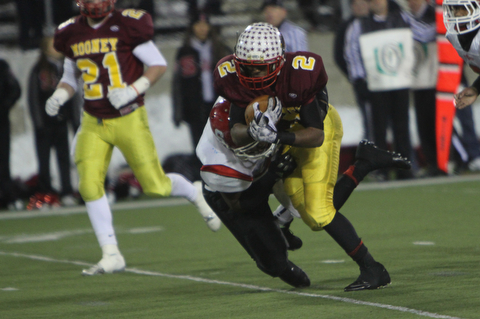 Cardinal Mooney's C.J. Amill (2) picks up a few tough yards while being dragged down by Steubenville's Arin Goldsmith (42) during the second half of Friday nights Division four Semi-Finals matchup at Fawcett Stadium in Canton. Amill rushed 17 times for 82 yards and a touchdown in Mooney's 37-7 victory over the Big Red.  Dustin Livesay  |  The Vindicator  11/29/30  Fawcett Stadium, Canton Ohio.