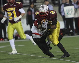 Cardinal Mooney's C.J. Amill (2) picks up a few tough yards while being dragged down by Steubenville's Arin Goldsmith (42) during the second half of Friday nights Division four Semi-Finals matchup at Fawcett Stadium in Canton. Amill rushed 17 times for 82 yards and a touchdown in Mooney's 37-7 victory over the Big Red.  Dustin Livesay  |  The Vindicator  11/29/30  Fawcett Stadium, Canton Ohio.