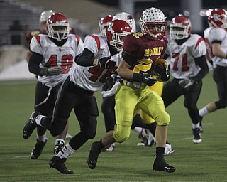Cardinal Mooney's Mark Handel (22) runs through the Steubenville defense with Branden Jones (46) on his heels during the second half of Friday nights Division four Semi- Finals at Fawcett Stadium in Canton.  Handel rushed 14 times for 52 yards during the Cardinals 37-7 victory over Big Red.    Dustin Livesay  |  The Vindicator  11/29/30  Fawcett Stadium, Canton Ohio.