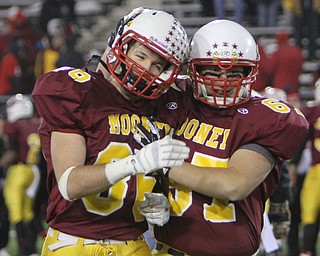 Cardinal Mooney seniors Ryan Megyesi (86,left) and Dom Divencenzo (67) celebrate after time expired during the Division four Semi-Finals matchup against Steubenville at Fawcett Stadium in Canton on Friday night.  The Cardinals beat Steubenville37-7 and advance to the State Championship game against Clarksville Clinton-Massie.  Dustin Livesay  |  The Vindicator  11/29/30  Fawcett Stadium, Canton Ohio.