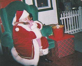Santa gets a hug from Leilani Pete, age 5. Sent by grandmother Othella May.
