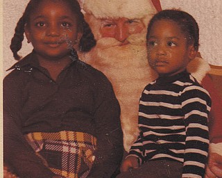 Sisters Carol and Nechelle Thomas are sitting on Santa's lap. Sent by Aunt Othella May.