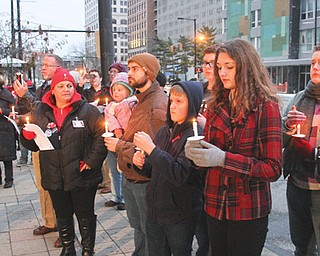 Twenty-five people gather in front of the Mahoning County Courthouse to observe World AIDS Day. Sunday’s vigil and walk through downtown aimed to raise awareness of HIV, dispel the stigma attached to it and honor those who died of AIDS. Tammy Bellish of Struthers, top, spoke at the vigil.