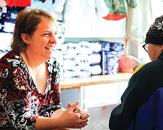 Melanie Rauschenbach, owner of Kid’s Stuff in Struthers, talks with the son of a customer, Cody Straley, 14. The children’s resale shop recently moved from State Street to Lowellville Road.