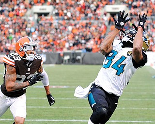 Jacksonville Jaguars wide receiver Cecil Shorts (84) catches a 20-yard touchdown pass against Cleveland Browns cornerback Joe Haden (23) in the fourth quarter of a game Sunday in Cleveland. The score gave the Jaguars a 32-28 win over the Browns.