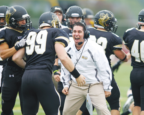 Cardinal Mooney High graduate Frank Colaprete, center, is the head coach for the College of Wooster. This season, the Fighting Scots went 7-3.