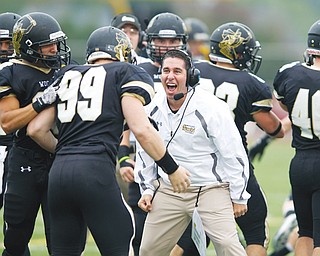Cardinal Mooney High graduate Frank Colaprete, center, is the head coach for the College of Wooster. This season, the Fighting Scots went 7-3.