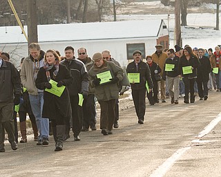 Local social-service agency leaders march on Monday from the St. Vincent de Paul Society soup kitchen on Front Street in downtown Youngstown to the Rescue Mission of Mahoning Valley on Martin Luther King Jr. Boulevard, also in Youngstown, symbolically tracing the footsteps of homeless people, who often make this trek in harsh winter weather.