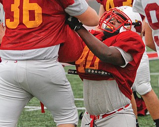 Mooney players Anthony Dermotta (36) and Andrew Armstrong (40) run through drills at Monday’s practice at The WATTS at YSU. The team meets Clinton-Massie on Friday for a Division IV state title.