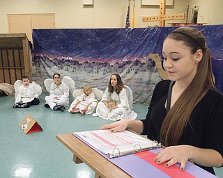 Kayliegh Crumb, 16, is the narrator for the Christmas pageant at the parish as “angels” listen to the story of the first Christmas.