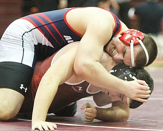 Fitch’s Blake Hibbs, top, tries to pin Boardman’s AJ Yaist during their match in the 220-pound weight class
of a tri-meet at Boardman High School on Thursday. Hibbs succeeded in pinning Yaist, and the Falcons took down the Spartans, 54-10, as well as the Howland Tigers, 53-15. Howland topped Boardman, 40-30.