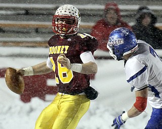 William D Lewis the Vindicator Mooney'sQB Jon Saadey(16) eludes Clinton defenderChayse Wolf(7).