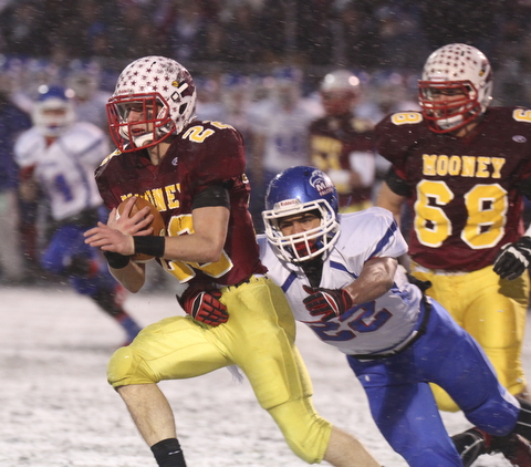 William D Lewis the Vindicator  Mooney's Mark Handel(22) eludes Clinton's Isaiah Stiverson(22).