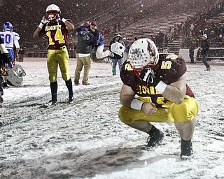 William D Lewis the Vindicator  Mooney's Nick Bilas(59) and Desmond Ford(14 react to loss as Clinton fans celebrate in background after 27-21 game in Massilon.