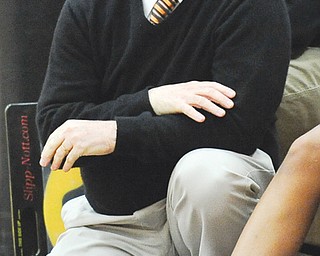 Howland head coach John Diehl watches from the bench during Thursday’s game against Warren Harding at Howland. The Tigers downed the Raiders, 53-43, to earn Diehl his 400th career win.