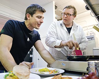 CEO Josh Tetrick, left, watches as research and development chef Trevor Niekowal makes a plant-based
scrambled egg at Hampton Creek Foods in San Francisco. Can plants replace eggs? A San Francisco startup backed by Bill Gates believes they can. Hampton Creek Foods is scouring the planet for plants that can replace chicken eggs in everything from cookies to omelets to French toast.