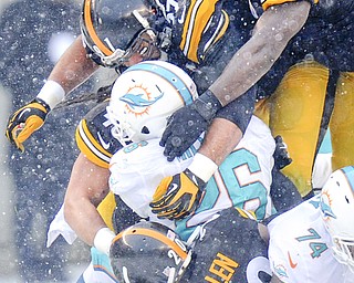 Miami Dolphins running back Lamar Miller (26) is tacked by Steelers inside linebacker Lawrence Timmons, top, defensive end Cameron Heyward and cornerback Cortez Allen during the second half of Sunday’s game in Pittsburgh. Miami won 34-28.