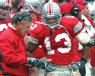 Ohio State coach Jim Tressel talks with freshman tailback Maurice Clarett in this game from 2002. Their departures from Ohio State will be documented in ESPN’s film “Youngstown Boys” that will be televised on Saturday.