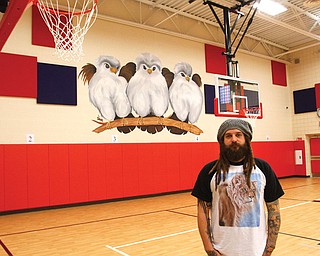 Aaron Chine, owner of Chinebox Ink on Mahoning Avenue, is the painter of murals at the Austintown schools. The murals depict falcons in various stages at each of the district’s four schools. Chine, a Fitch High graduate, says he has always been into art and works with all forms.