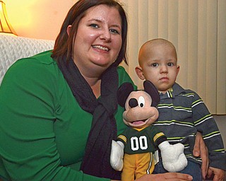 Sixteen-month-old Dalton Bodnar relaxes with his mother, Dana Bodnar, and his Mickey Mouse toy. Dalton, who has been declared cancer-free after three rounds of chemotherapy, will be the guest of honor with VIP seats at tonight’s opening performance of “Disney on Ice” at the Covelli Centre.