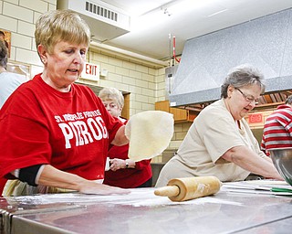 Tess Szenborn, above left, and Paulette Jamrozik roll out dough to make kolachi during a Wednesday baking session at St. Joseph the Provider Church of Christ, The Good Shepherd Parish in Campbell. They’re preparing for a Cookie Walk on Saturday sponsored by St. Joseph Cultural Society. Below, dough is spread with a layer of nuts during the kolachi-making project. The Cookie Walk will feature homemade cookies including clothespin and pizzelles along with kolachi.