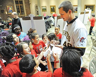 Pirates pitcher Jared Hughes signs autographs for Campbell fourth graders during the Pirates caravan Wednesday night at the Butler Institute of American Art in Youngstown.