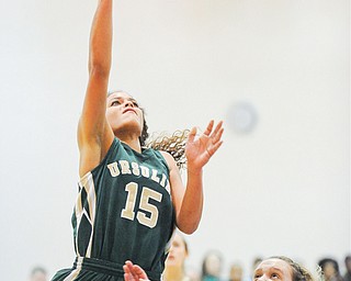 Ursuline’s Macey Gunther puts up a shot under the basket as Harding’s Chelsea Dipaolo defends during Wednesday’s game at Warren Harding. Ursuline won 52-40.