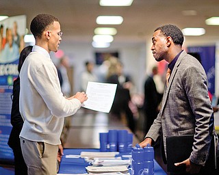 Retired U.S. Air Force Master Sgt. Thomas Gipson of Atlanta, right, has his resume looked over by Ralph Brown, a management and program analyst with the Centers for Disease Control and Prevention, during a job fair for veterans at VFW Post 2681in Marietta, Ga. The number of people seeking U.S. unemployment benefits rose 68,000 last week to a seasonally adjusted 368,000, the largest increase in more than a year.