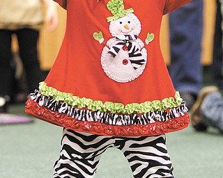 Adalyn DeLuca, 14 months, sings and moves to the music to touch her head, shoulders, knee and toes during
a Rhythm and Rhyme session. Dan DeLuca, Adalyn’s father, brought her to the session.