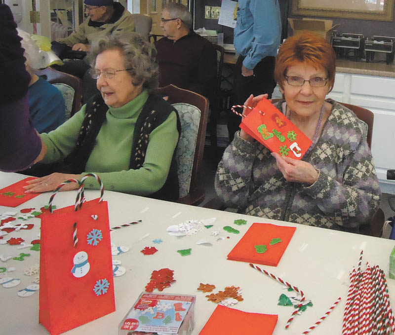 Special to The Vindicator: Residents of Whispering Pines Village in Columbiana recently enjoyed an afternoon of making Christmas crafts and their second annual bake sale. They raised more than $250, which will be donated to Toys for Tots. Resident crafters are Pernie Wukotich, left, and Donna Round.