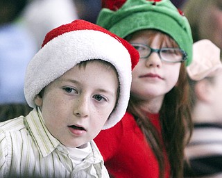 William D Lewis The Vindicator Tegan Looymans(correct), 1rst grade and Emily Chambers, 2nd grade, try to get a glimpse of Santa during Struthers Rotary Christmas party 12-17-13 at Struthes Presbyterian Church.They are students at Austintown elem School.