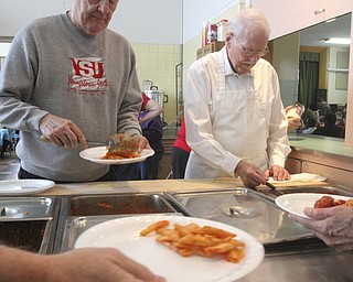 William D Lewis The Vindicator Volunteers Jim Watt, left, and Bill Liggett , both members of Struthers Presbyterian Church serve up lunch during Struthers Rotary Christmas party 12-17-13 at Struthers Presbyterian Church.