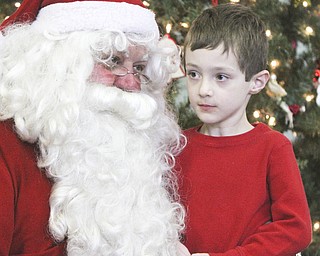 William D Lewis The Vindicator Zachary Stillerman, kindergarten student from Canfield talks to Santa during Struthers Rotary Christmas party 12-17-13 at Struthers Presbyterian Church.