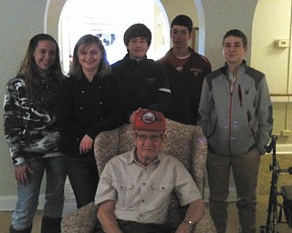 Members of Holy Family Youth Ministry recently visited Blackburn, Sunrise and Greenbriar care facilities to honor residents who are veterans. Standing behind
retired Sgt. George Henry of the U.S. Army Airborne Division are, from left, Courtney Conklin, Abbey Lea, Mark Stein, Jay Raymer and Robert Kurta. Henry is a resident of the Blackburn Home. HFYM is led by Maureen Kelty, director of religious education. Special to The Vindicator
SPECIAL TO THE VINDICATOR