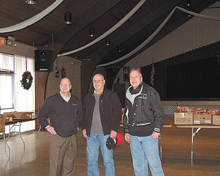 SPECIAL TO THE VINDICATOR:
The Kiwanis Club of Western Mahoning County distributed 68 food baskets to needy families Nov. 26. Some members who participated are, from left, Rob Gardner, Tom Eisenbraun and Don Augenstein. The club also is sponsoring three free photo opportunities with Santa at Farmers National Bank, 20 S. Broad St., Canfield. Parents can take children Saturday. Photo sessions will be from 9 a.m. to noon and will be available on a first-come, first-served basis.