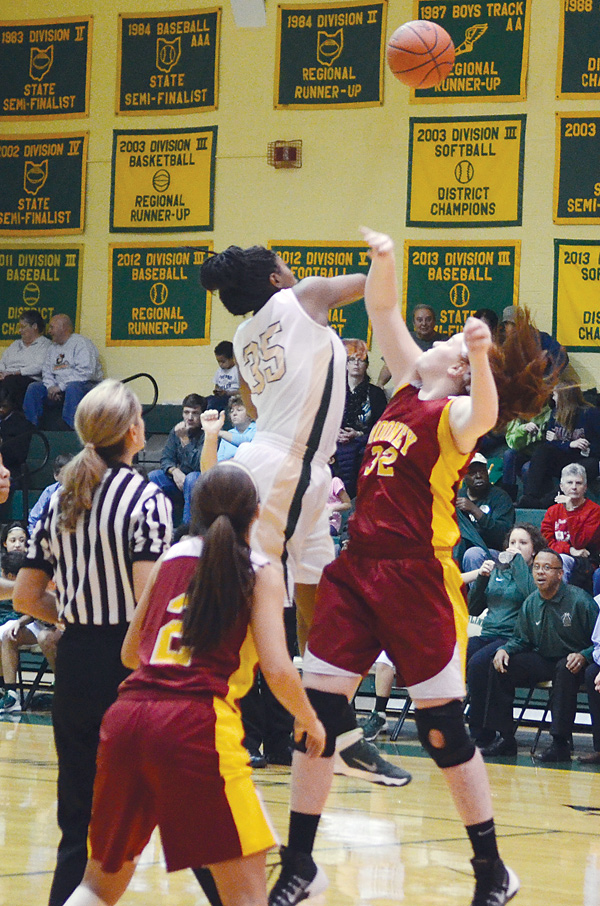 Ursuline’s Tanaya Beacham swats the ball away from Cardina Mooney’s Maggie Monahan at the start of Wednesday’s game at Ursuline High School. Beacham scored 18 points for the Irish, who downed the
Cardinals, 47-39.
