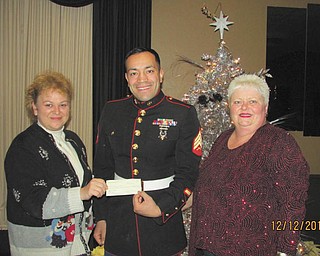 SPECIAL TO THE VINDICATOR
Warren Republican Women’s Club raised $2,200 during its annual Toys for Tots Auction early in December at McMenamy’s in Warren. In attendance for the check presentation were, from left, Kelly Pope, the club’s second vice president and chairman of the auction; U.S. Marine Sgt. Modesto Montano; and Cary Ann Koren, club president.
