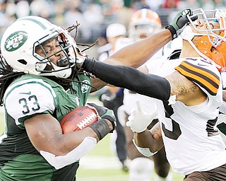 Jets running back Chris Ivory stiff -arms the Browns’ Joe Haden during the second half of their NFL game in East Rutherford, N.J. Cleveland coughed up a 10-0 lead to fall 24-13 to New York.