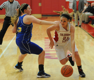 Columbiana #24 Emily Witmer dribbles around Southern defender #12 Abby Smalley on her way to the basket during the 1st half of Monday nights game.