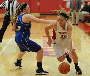 Columbiana #24 Emily Witmer dribbles around Southern defender #12 Abby Smalley on her way to the basket during the 1st half of Monday nights game.