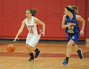Columbiana #13 Mariah Rovnak dribbles the ball up court away from Southern defender #20 Natalie Utt during the 1st half of Monday nights game.