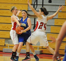 Southern #3 Mickenzie Mouts attempts to escape from the Columbiana #24 Emily Witmer and #5 Baylie Mook during the 2nd half of Monday nights game.