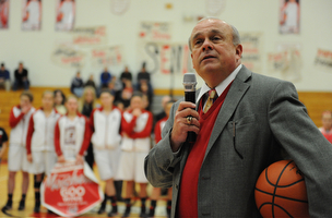 Columbiana head coach Ron Moschella speaks over the PA system while holding the game ball after his 600th career win Monday night.