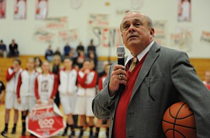 Columbiana head coach Ron Moschella speaks over the PA system while holding the game ball after his 600th career win Monday night.