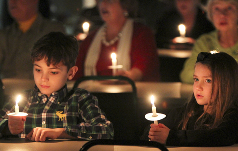 William D Lewis The Vindicator Sebastian Timko, 9, and his sister Kendall Timko, 5, hold candles and sing Silent Night during Christmas Eve service at Western Reserve United Methodist Church in Canfield. They are children of Justin and Valerie Timko of Boardman.