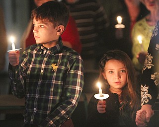 William D Lewis The Vindicator Sebastian Timko, 9, and his sister Kendall Timko, 5, hold candles and sing Silent Night during Christmas Eve service at Western Reserve United Methodist Church in Canfield. They are children of Justin and Valerie Timko of Boardman.