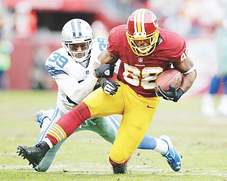Washington Redskins receiver Pierre Garcon, a former standout at Mount Union University, is tackled by Dallas Cowboys cornerback Brandon Carr during the second half of their game Sunday.
