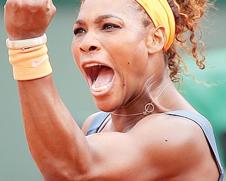 Serena Williams celebrates a winning point as she plays Russia’s Maria Sharapova during the final match of the French Open.