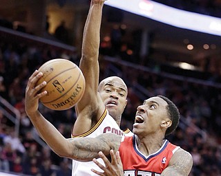 Atlanta Hawks’ Jeff Teague (0) jumps to the basket against Cleveland Cavaliers’ Jarrett Jack during the third
quarter of a game Thursday in Cleveland. Teague made a game-winner at the buzzer of the second overtime
for a 127-125 victory over the Cavaliers.